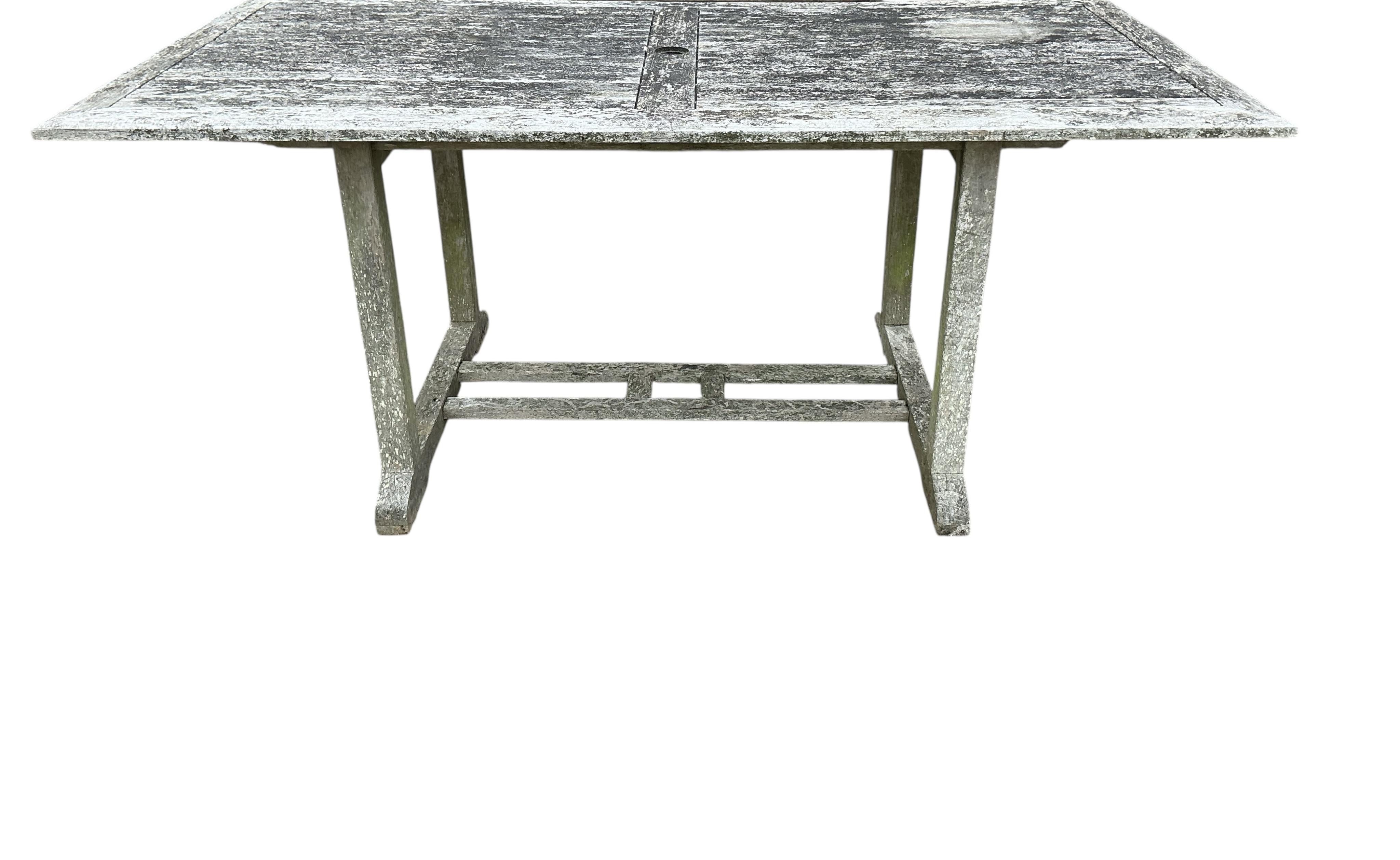 A rectangular weathered teak garden table, width 178cm, depth 90cm, height 72cm together with six Lindsey teak folding garden chairs